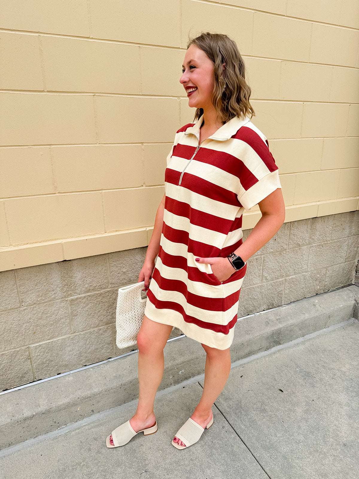 Mini dress with a zippered split-neck collar, cuffed sleeves, and colorblock-style stripes—sporty, stylish, and perfect for Gameday wear.