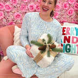 Two-piece lounge set in ivory with light blue and grey abstract animal print, crew neck top, and wide-leg pants with drawstring.