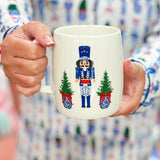 White ceramic mug featuring nutcracker illustration from the Nutcracker Dreams print.