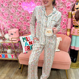 Pastel floral pajama set with long sleeves and matching pants in pink, blue, green, and orange