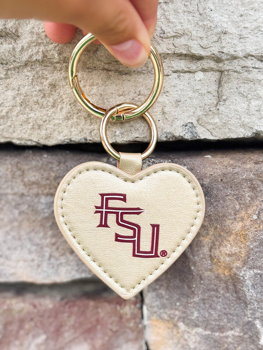 Gold heart-shaped purse charm with garnet FSU logo and gold-toned hardware, ideal for bags or keys.