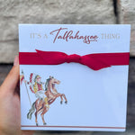Square notepad with “It’s a Tallahassee Thing” in garnet and gold, gold edges, coordinating ribbon, and Osceola and Renegade illustration in the corner.