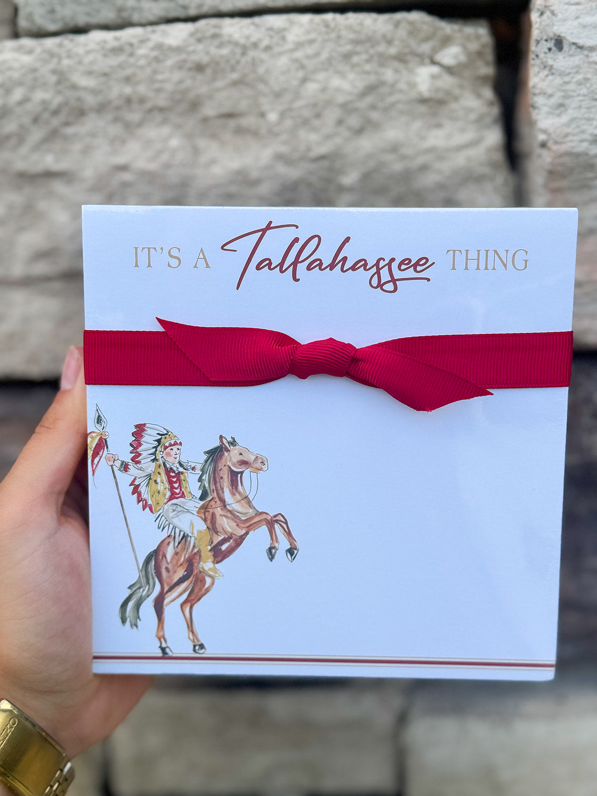 Square notepad with “It’s a Tallahassee Thing” in garnet and gold, gold edges, coordinating ribbon, and Osceola and Renegade illustration in the corner.