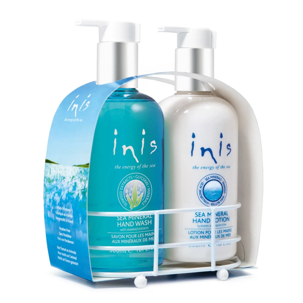 White metal caddy holding two 10 oz. bottles of Inis hand soap and hand lotion with coastal blue labels.