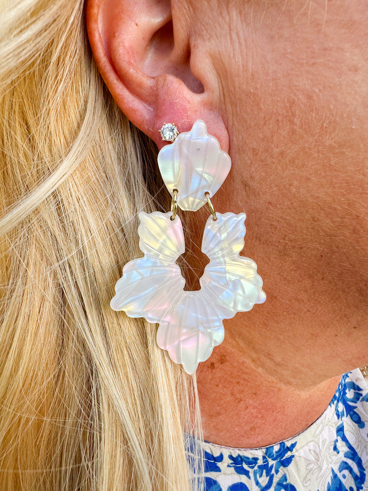 Long iridescent statement earrings with blue, mint, pink, and purple tones, inspired by seashells and crafted from eco-friendly materials