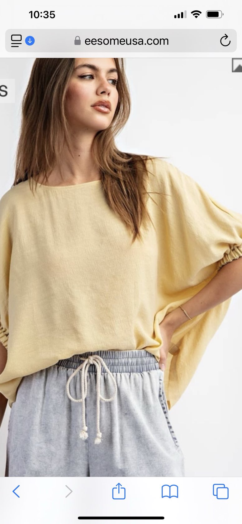 Golden yellow short sleeve blouse with a relaxed fit and dolman sleeves, styled for casual or dressy occasions.