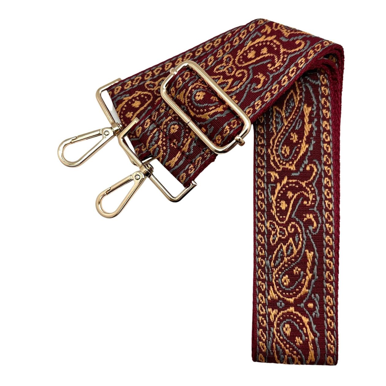 Garnet paisley fabric bag strap with gold hardware, styled with a clear gameday bag