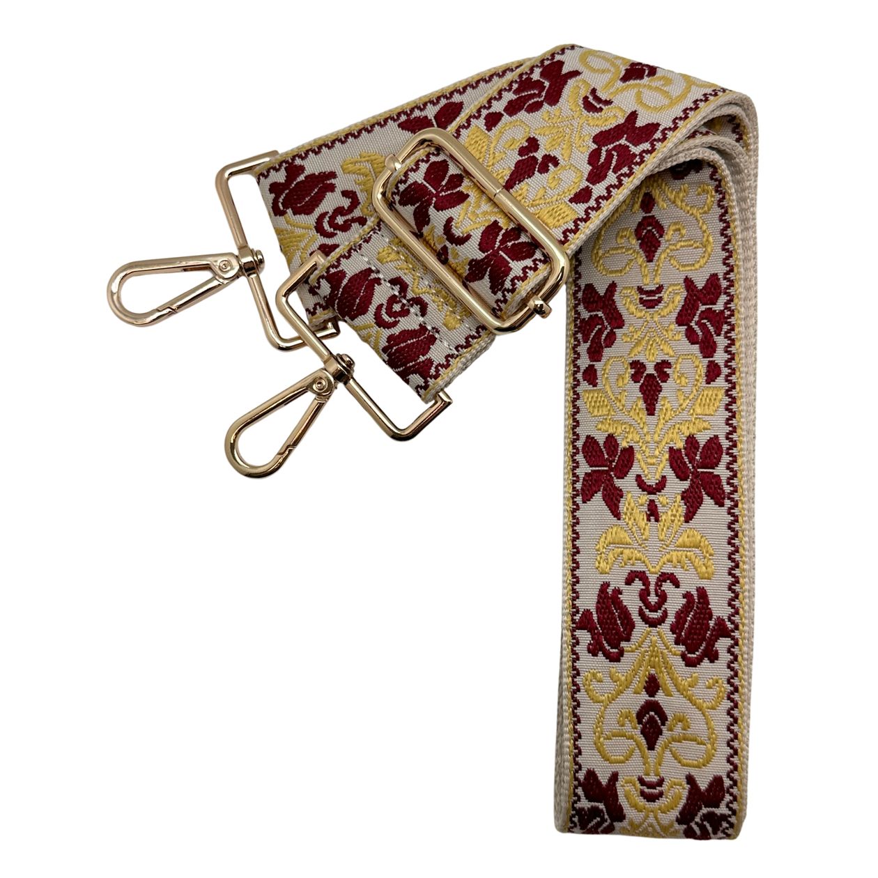 Ivory woven bag strap with garnet and gold detailing, shown with gold hardware on a crossbody bag