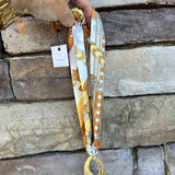 Cream, tan, and yellow scarf necklace with hammered gold open teardrop pendant, handmade by Hart Designs.