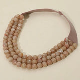 Caramel triple-layer chunky bead necklace with faux leather cords and magnetic clasp.