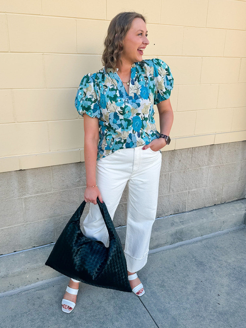 Blue floral blouse with pink accents, featuring a ruffle-trimmed split neckline and short puff sleeves