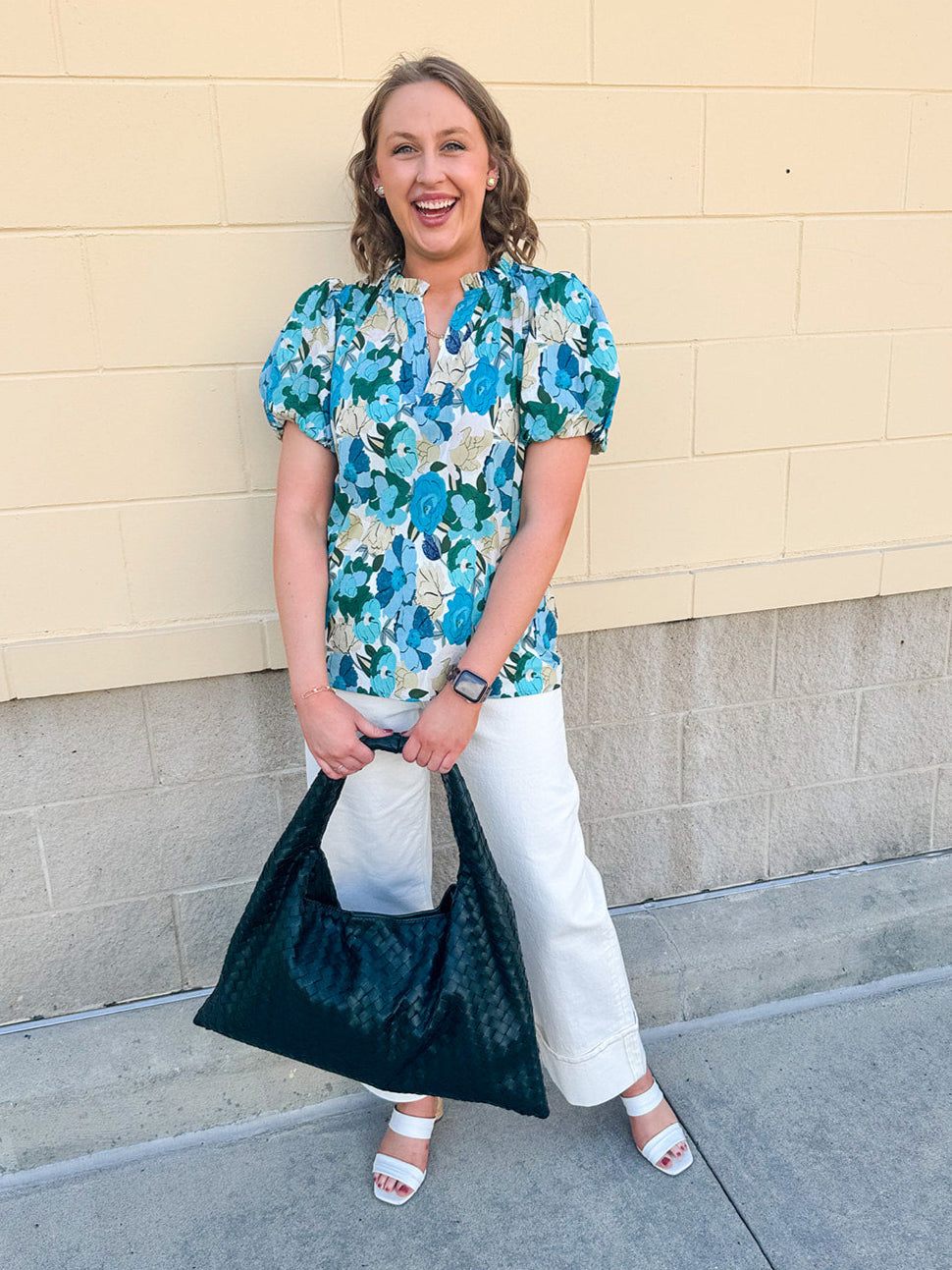Blue floral blouse with pink accents, featuring a ruffle-trimmed split neckline and short puff sleeves