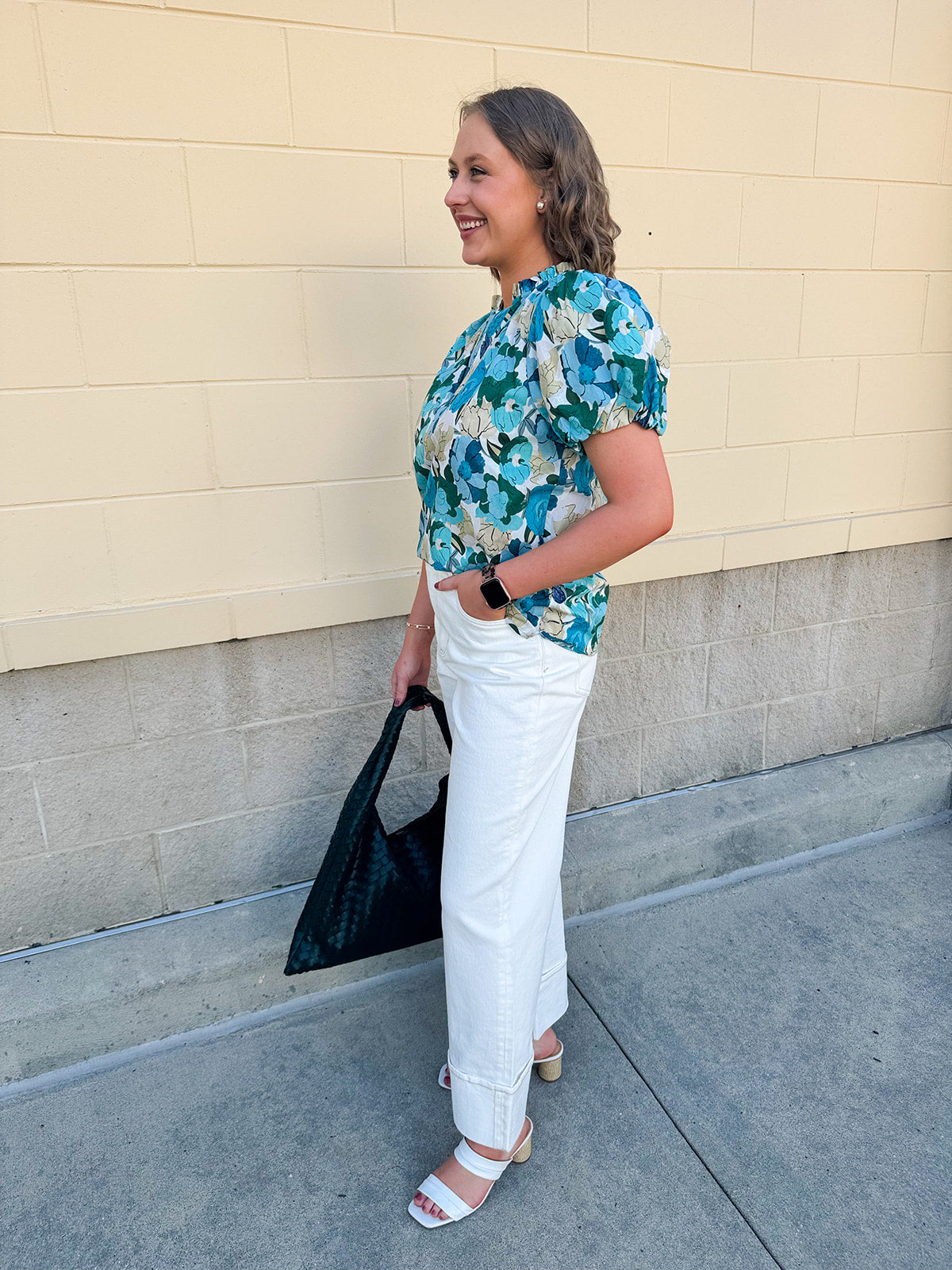 Blue floral blouse with pink accents, featuring a ruffle-trimmed split neckline and short puff sleeves