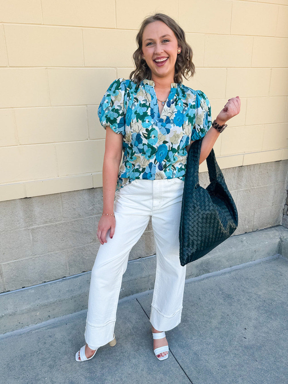 Blue floral blouse with pink accents, featuring a ruffle-trimmed split neckline and short puff sleeves