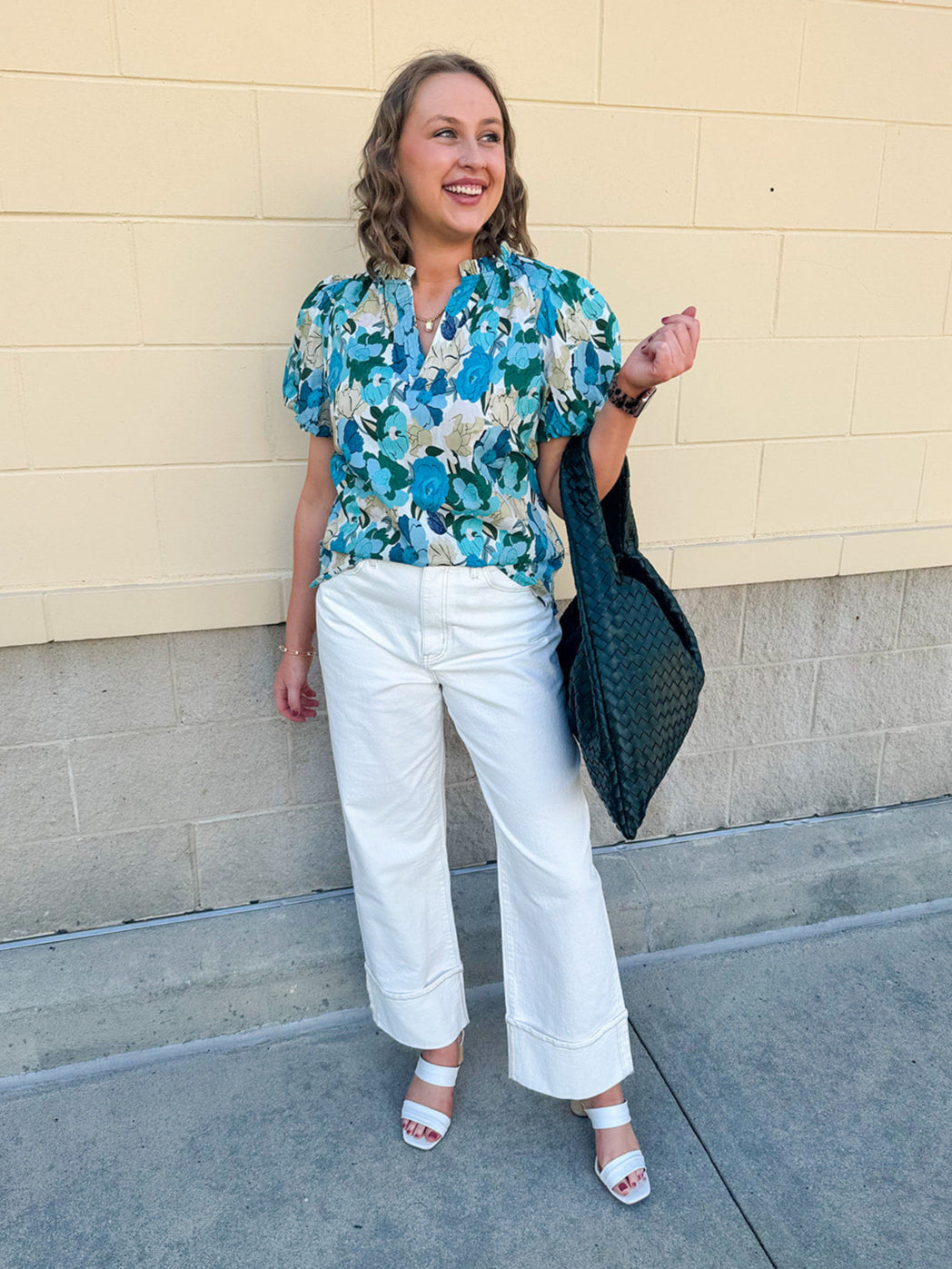Blue floral blouse with pink accents, featuring a ruffle-trimmed split neckline and short puff sleeves