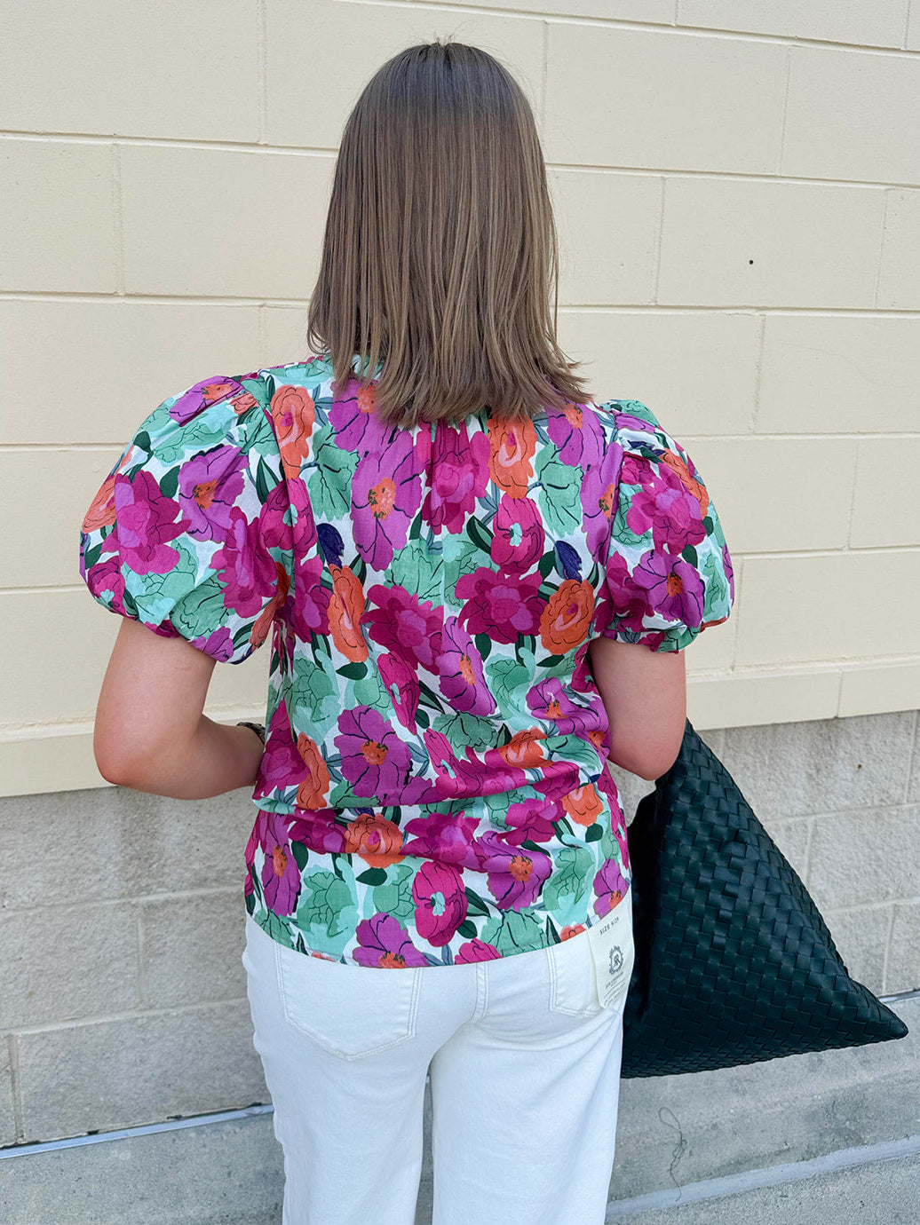 Vibrant raspberry floral blouse with ruffle-trimmed split neckline and short puff sleeves