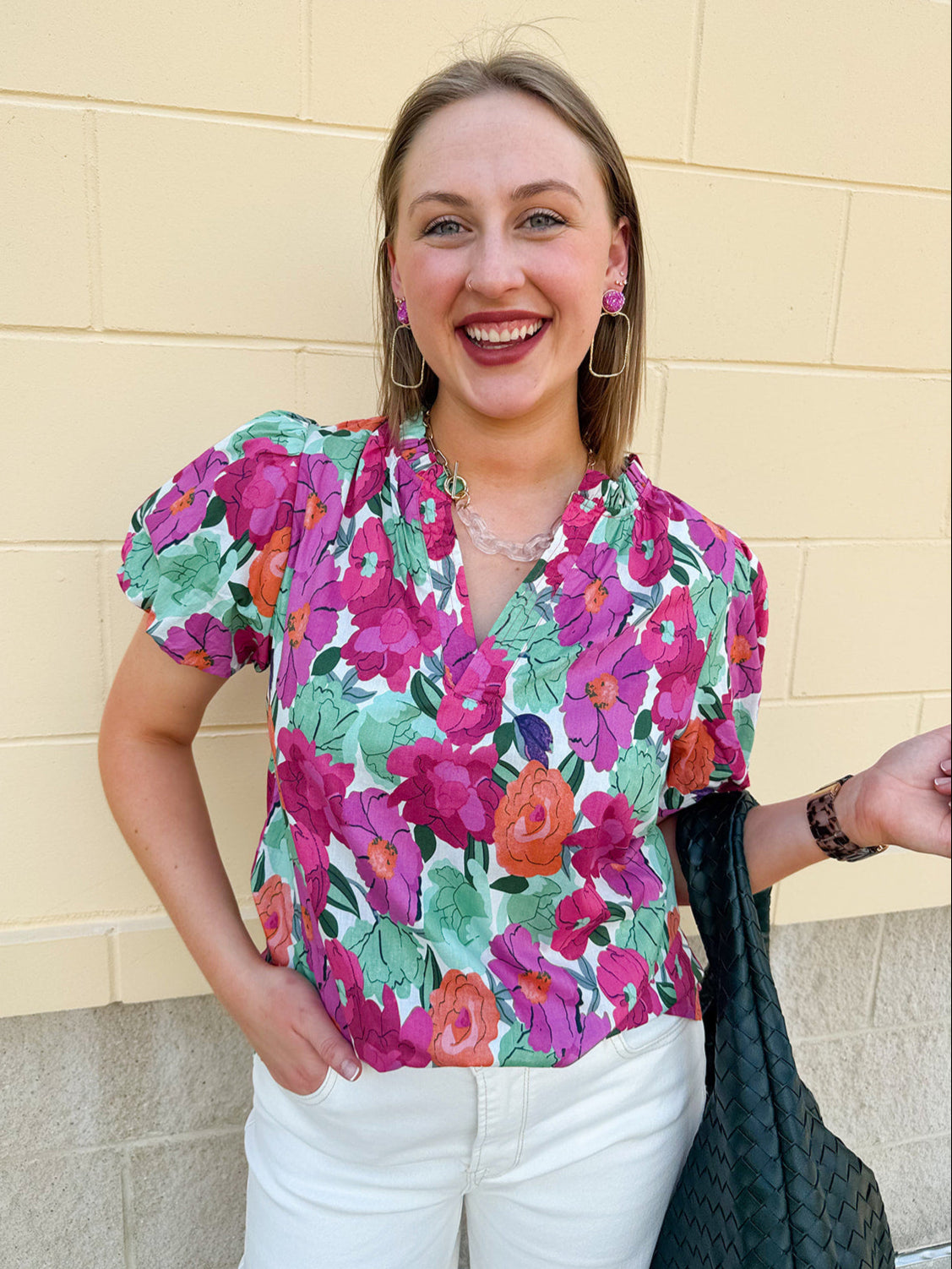 Vibrant raspberry floral blouse with ruffle-trimmed split neckline and short puff sleeves