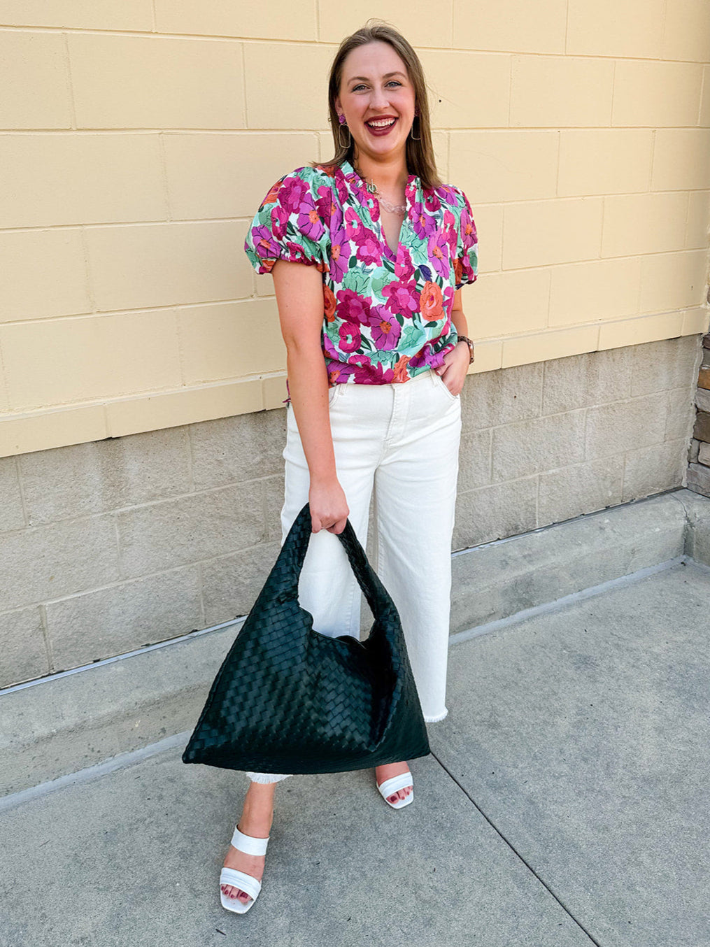 Vibrant raspberry floral blouse with ruffle-trimmed split neckline and short puff sleeves