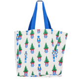 White everyday tote with nutcracker and Christmas tree print and blue handles.