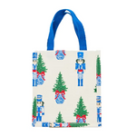 White compact tote with nutcracker and tree print and blue handles.