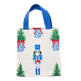 White petite square tote with nutcracker and Christmas tree print, blue handles.