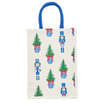 White wine caddy with nutcracker and Christmas tree print, blue handles.