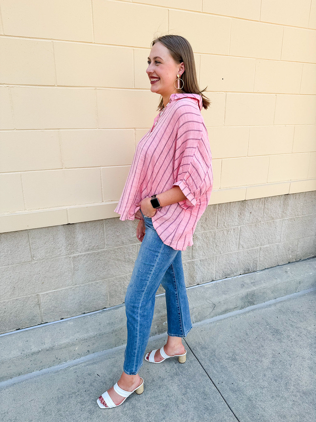 Oversized pink striped cotton gauze blouse with collar, button-down front, drop shoulders, and half sleeves.