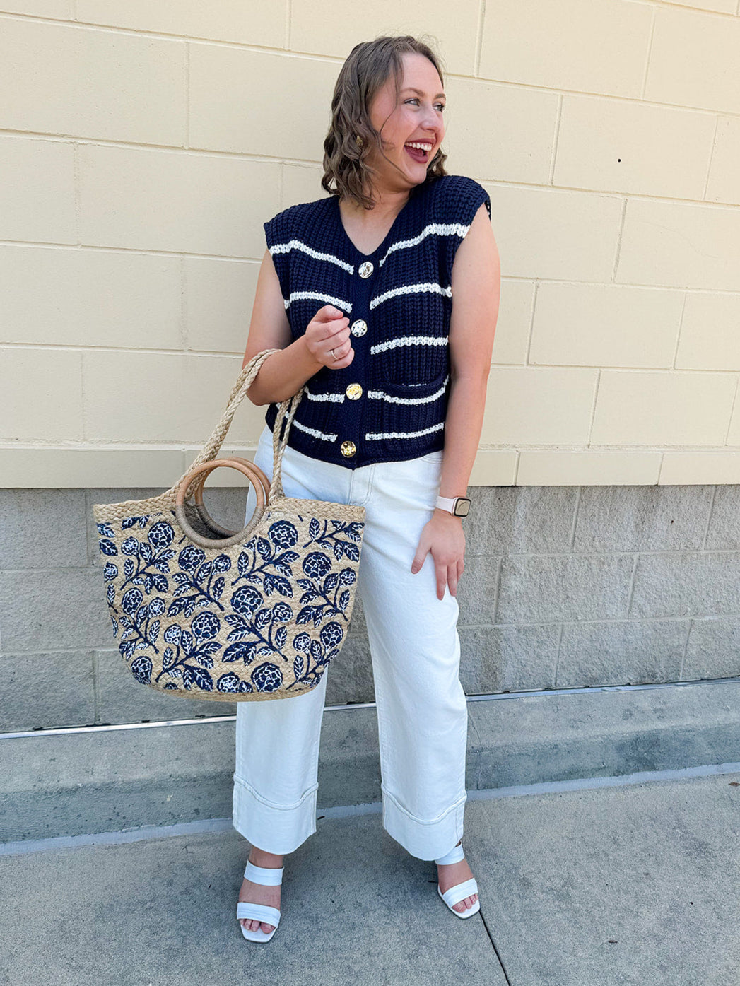 Navy and white striped crochet vest with front pockets, buttons, and sleeveless relaxed fit.
