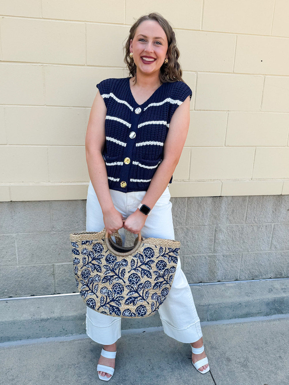 Navy and white striped crochet vest with front pockets, buttons, and sleeveless relaxed fit.