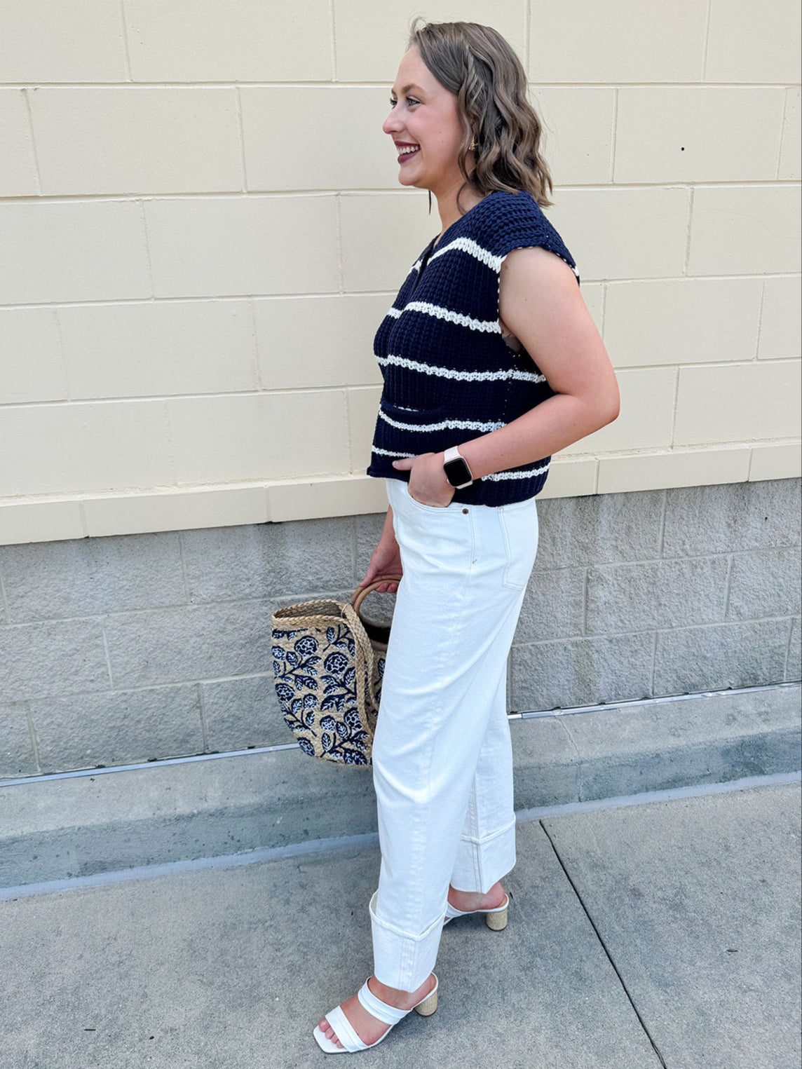 Navy and white striped crochet vest with front pockets, buttons, and sleeveless relaxed fit.