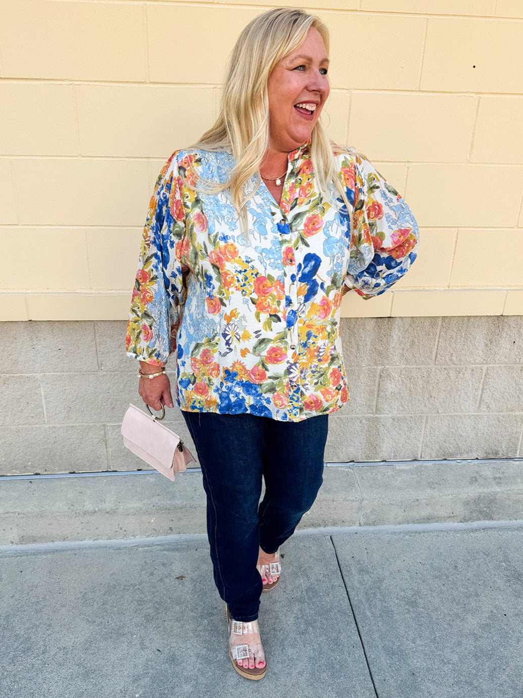 Floral chiffon blouse with frilled neckline, button front, dolman sleeves, and lightweight, flowy fit.