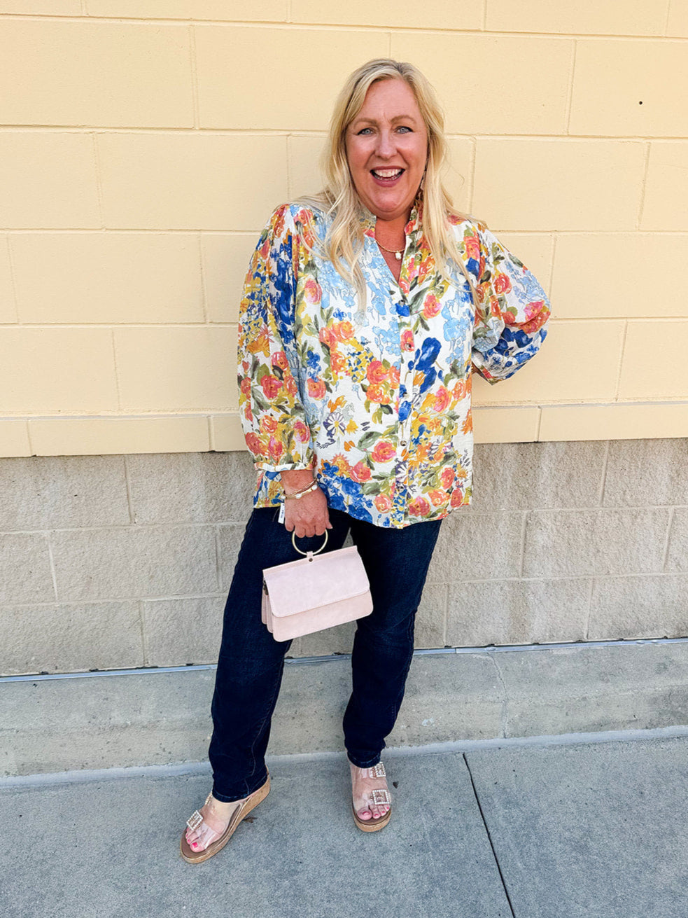 Floral chiffon blouse with frilled neckline, button front, dolman sleeves, and lightweight, flowy fit.