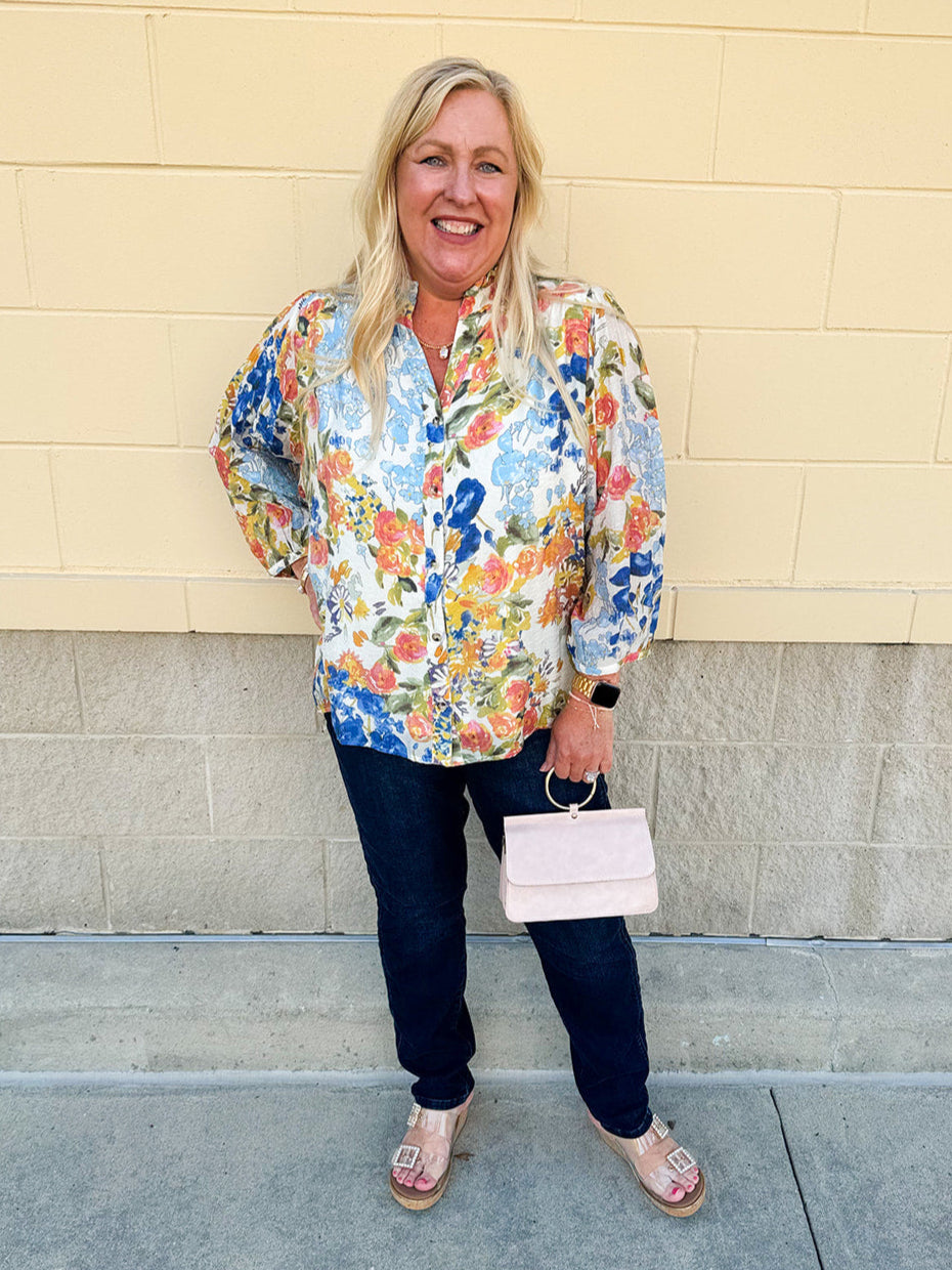 Floral chiffon blouse with frilled neckline, button front, dolman sleeves, and lightweight, flowy fit.
