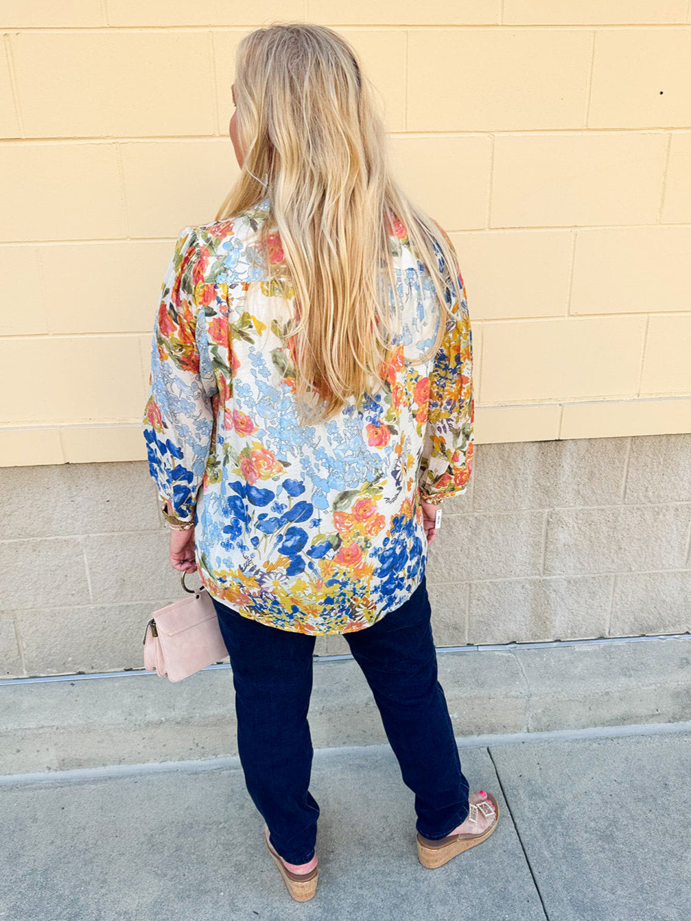 Floral chiffon blouse with frilled neckline, button front, dolman sleeves, and lightweight, flowy fit.