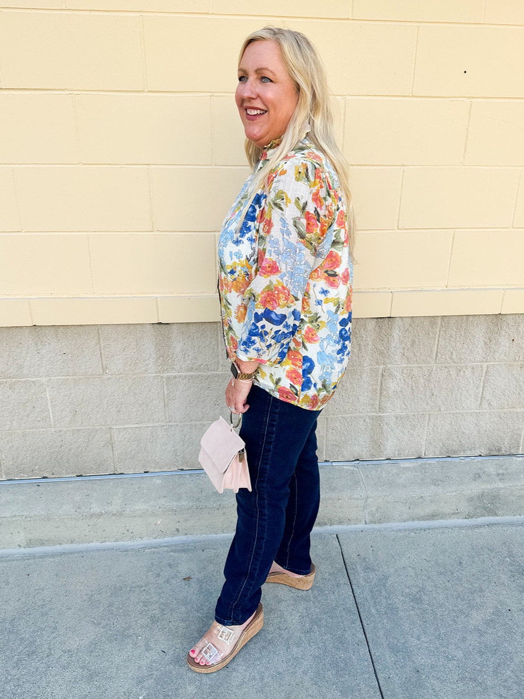 Floral chiffon blouse with frilled neckline, button front, dolman sleeves, and lightweight, flowy fit.