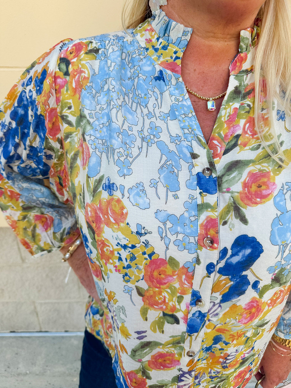 Floral chiffon blouse with frilled neckline, button front, dolman sleeves, and lightweight, flowy fit.
