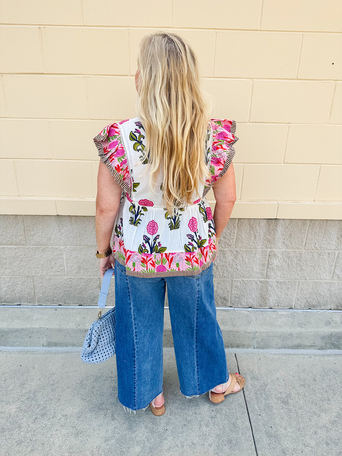 White cotton flutter sleeve top with floral print and ruffle neckline