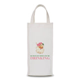 White fabric wine bag with Santa head in pink hat and text reading “He Sees You When You’re Drinking.”