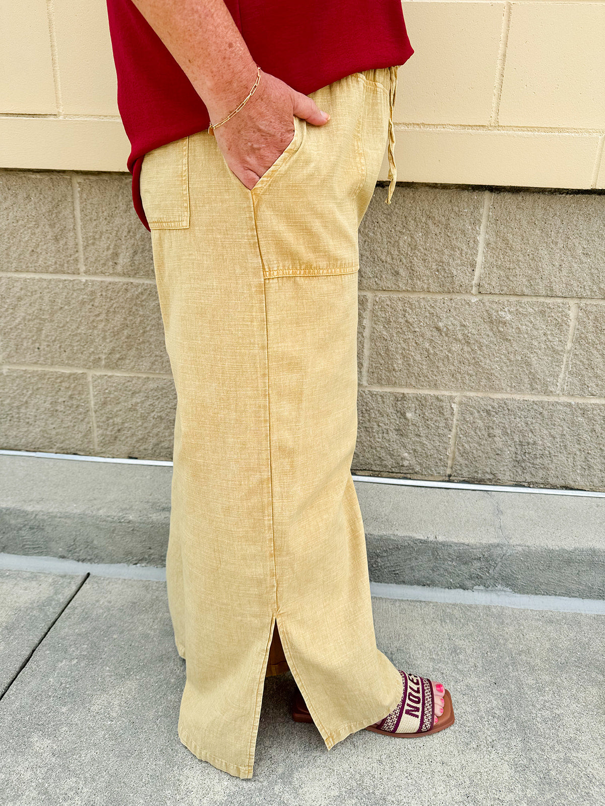 Golden wide-leg linen-blend pants with drawstring waist and square pockets—lightweight and perfect for casual gameday style