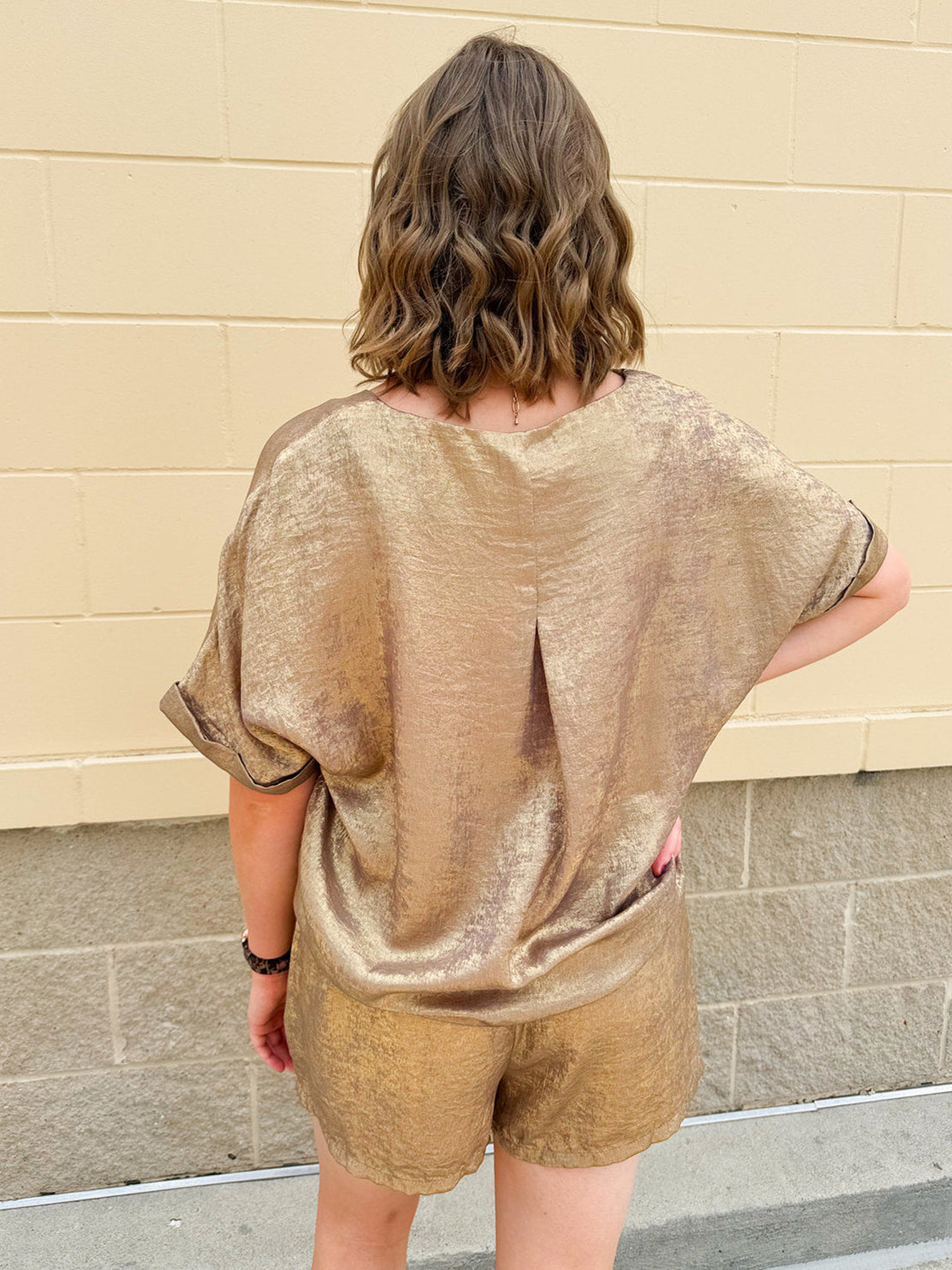 Metallic gold loungewear set with short dolman sleeve U-neck top and matching drawstring shorts