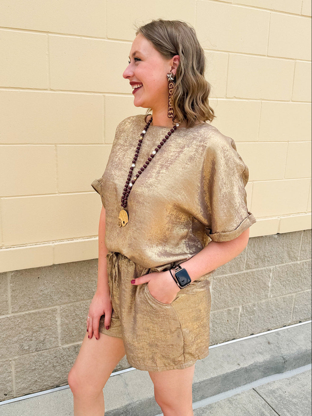 Metallic gold loungewear set with short dolman sleeve U-neck top and matching drawstring shorts
