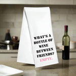 White kitchen towel with the phrase “What’s a bottle of wine between friends? Empty!”