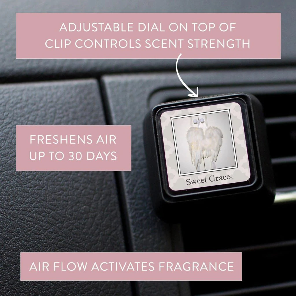 Compact car vent clip styled in a vehicle interior with neutral tones