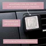 Compact car vent clip styled in a vehicle interior with neutral tones