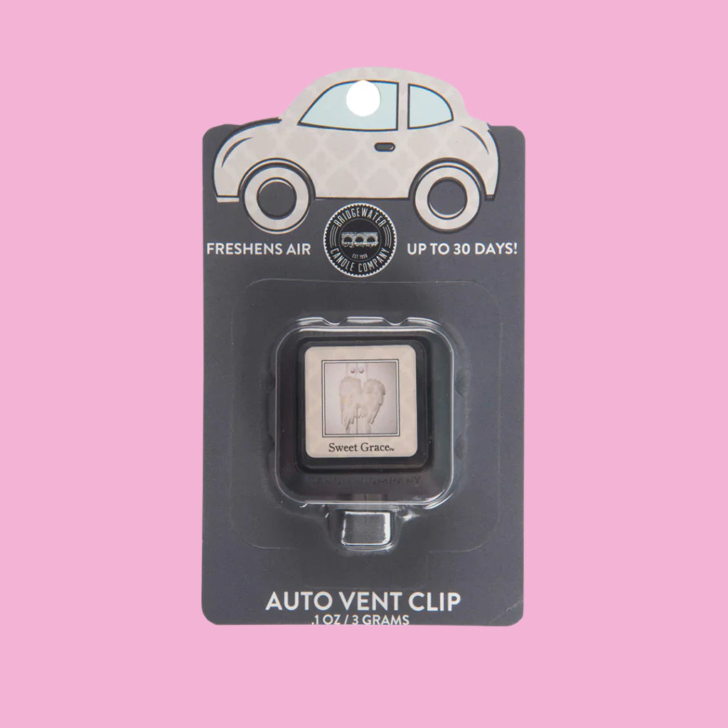 Compact car vent clip styled in a vehicle interior with neutral tones