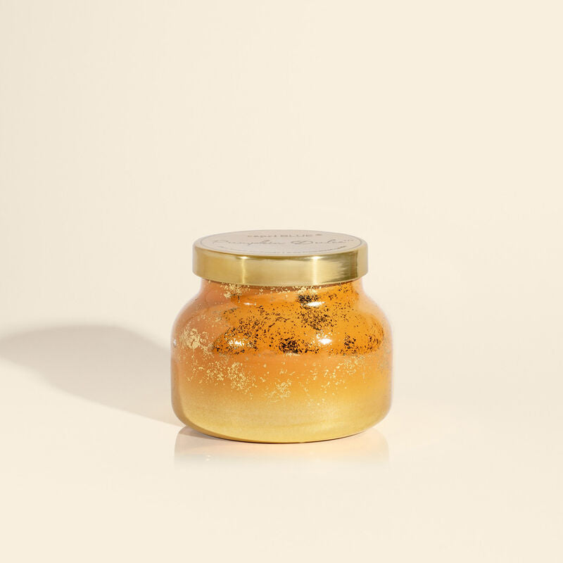 Petite cider-colored candle with gold detailing, fall-inspired