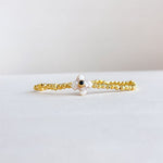 Stretch bracelet with alternating black onyx and pearl beads, accented with a gold-plated detail—chic, bold, and elegant.