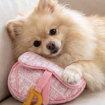 Pink plush saddle bag-shaped dog toy with a squeaker and crackle sound.