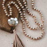 Debbie Pendant Necklace with Tassel in Champagne featuring leather tassel pendant and glass crystal bead necklace.