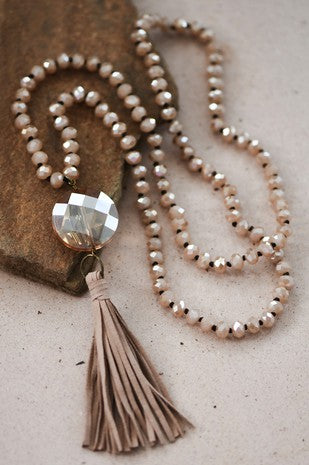 Debbie Pendant Necklace with Tassel in Champagne featuring leather tassel pendant and glass crystal bead necklace.